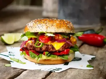 A burger on top of a table.